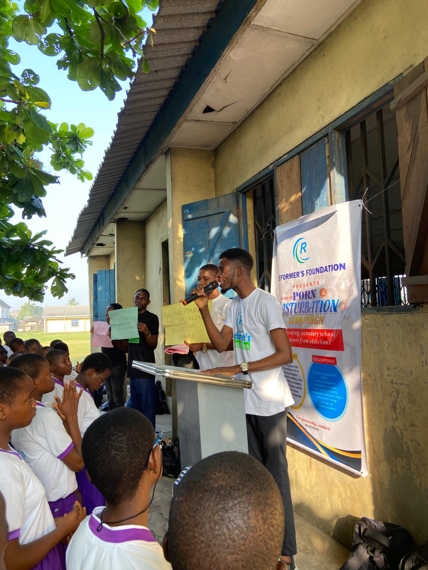 Founder addressing secondary school students during an outreach